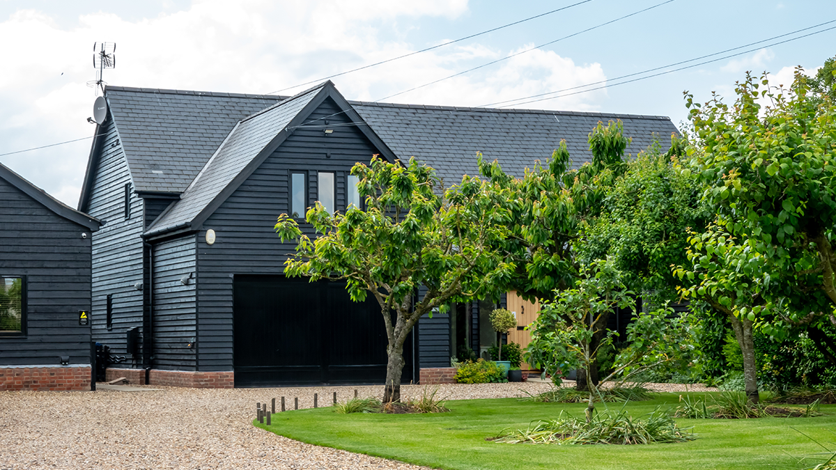 Large grey house with a black garage